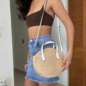 Woven bag with white arm strap and details